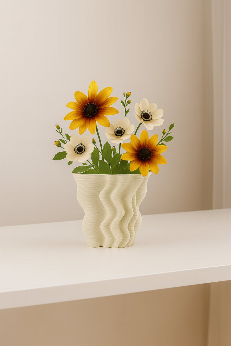 Wavy ceramic vase with sunflowers and anemones on white table. floralsuppliespoint1.com is a retail and wholesale vendor for ceramic vase products.