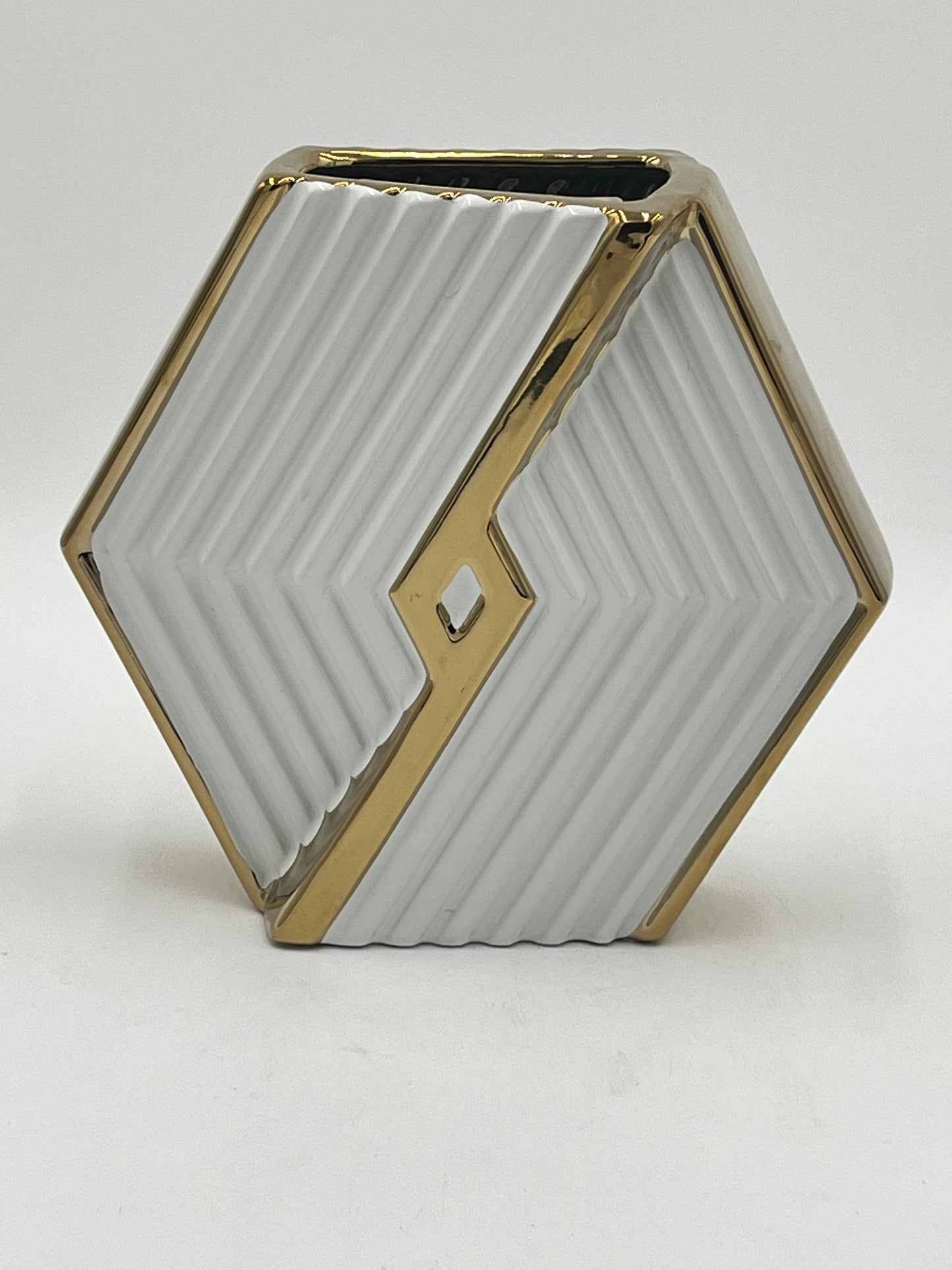 A hexagonal ceramic vases with gold trim in white, 9" x 4" and 3 lbs, ideal for floral designs. Available at floralsuppliespoint1.com