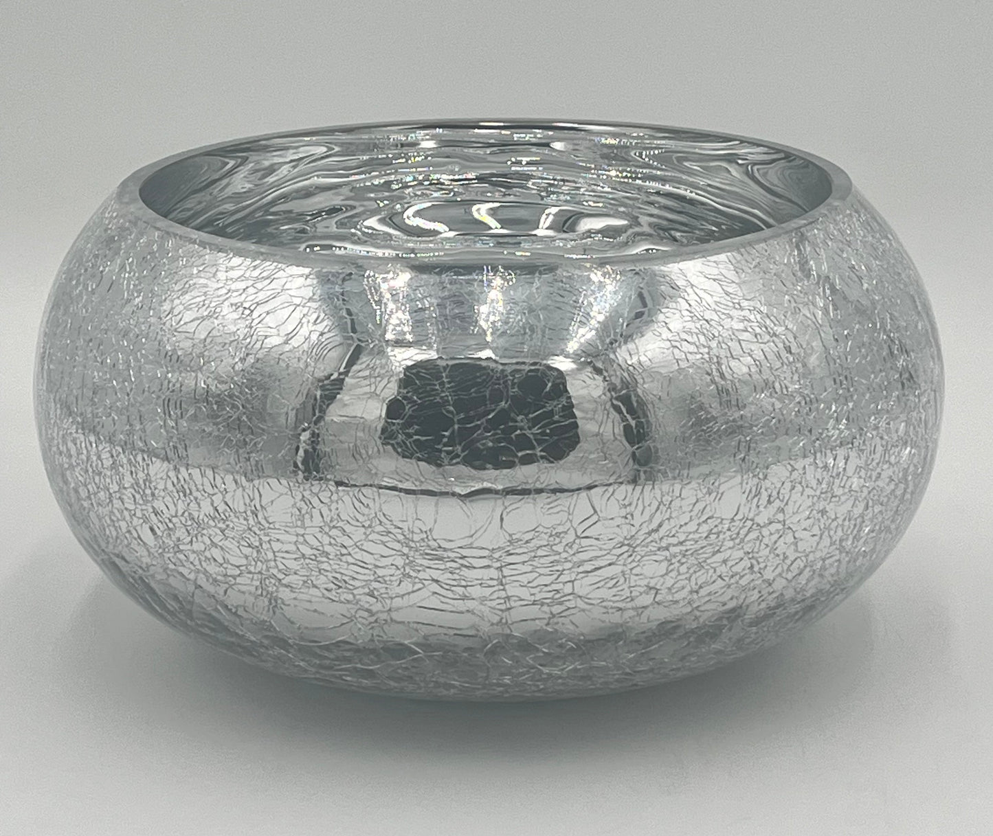 The Floral Supplies Point Crystallo Basin 5.25 x 7.25 Op is a round, silver bowl with a wide opening, featuring a reflective crackled exterior and smooth shiny interior, shown against a plain light gray background.