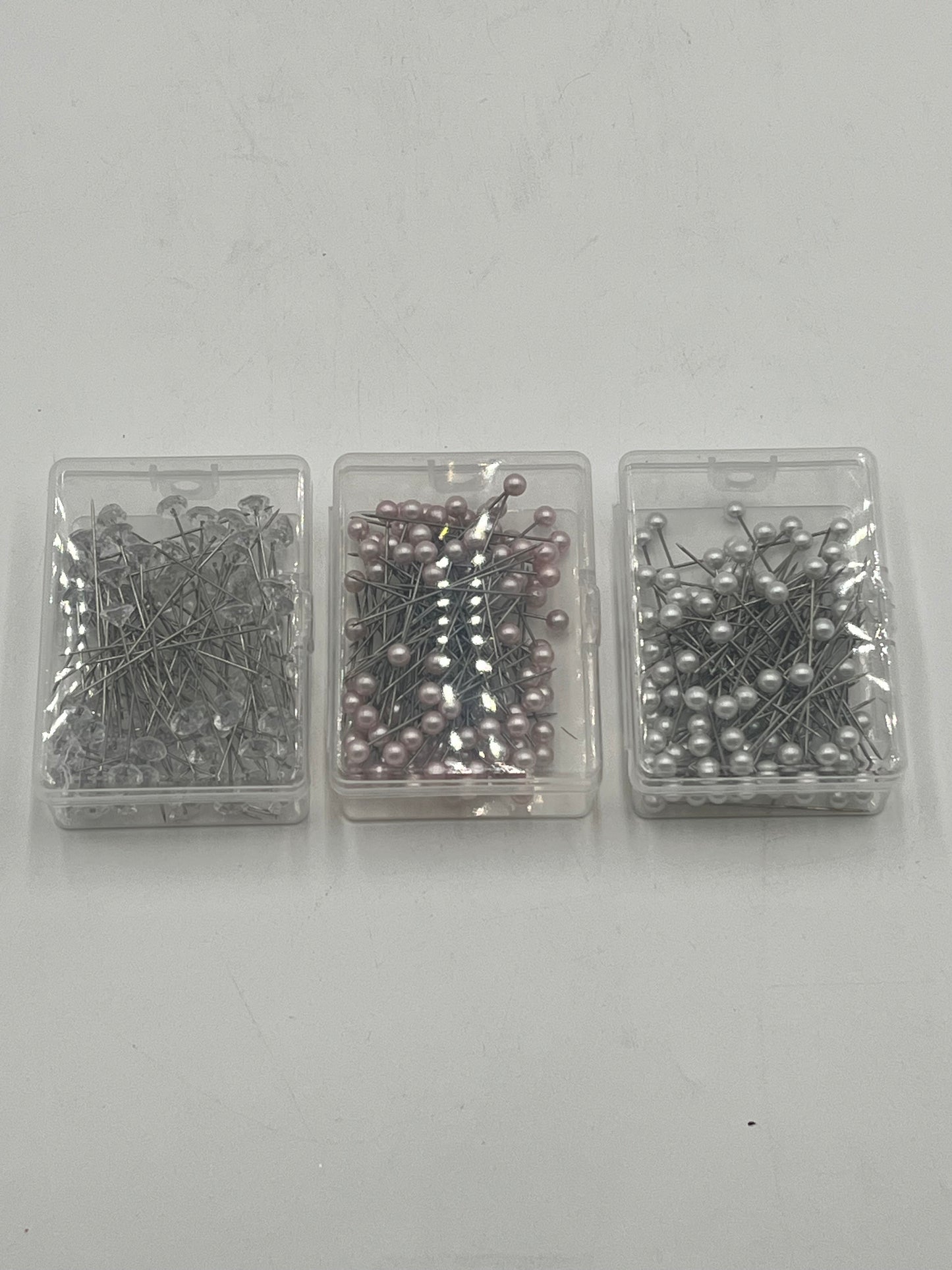 Decorative floral pins in pearl white, pink & diamond crystal styles, 50 pcs per box. Sold retail or wholesale 10-packs by floralsuppliespoint1.com.