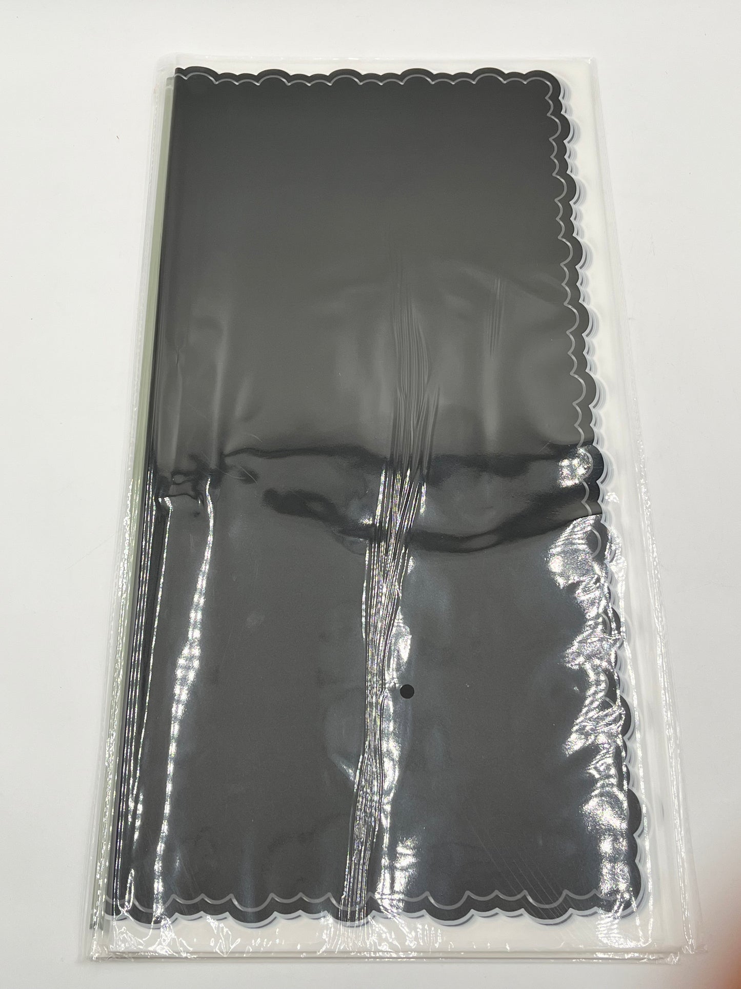 Black elegant scalloped wrapping paper, 22 in x 22 in, packs of 20 for $9.99. Perfect for flowers, gifts & crafts, sold by floralsuppliespoint1.com