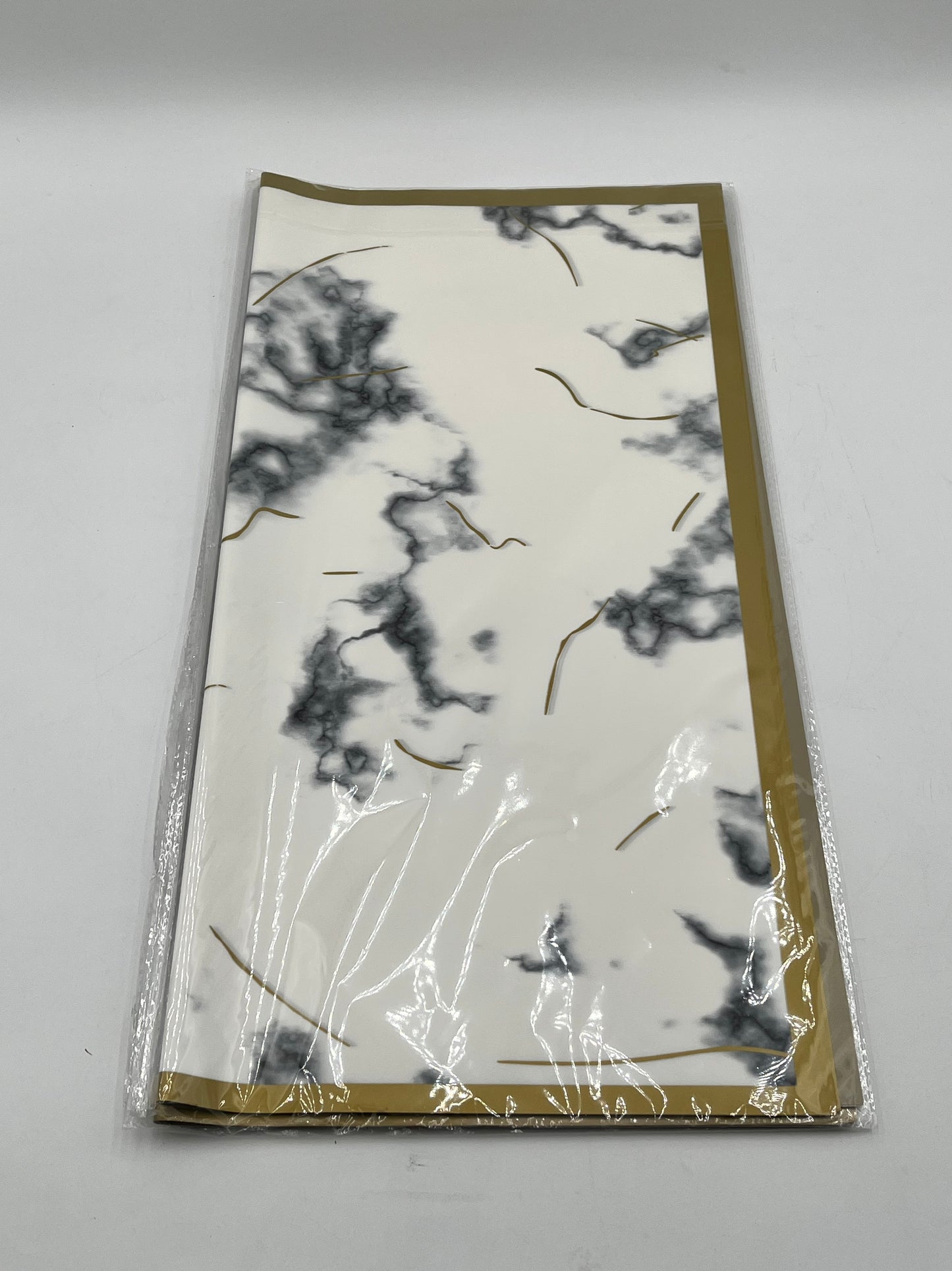 Gilded Marble Vein Trio 22x22 inch (20 sheets) wrapping papers in White with Gray Veins. Sold by floralsuppliespoint1.com for $9.99.