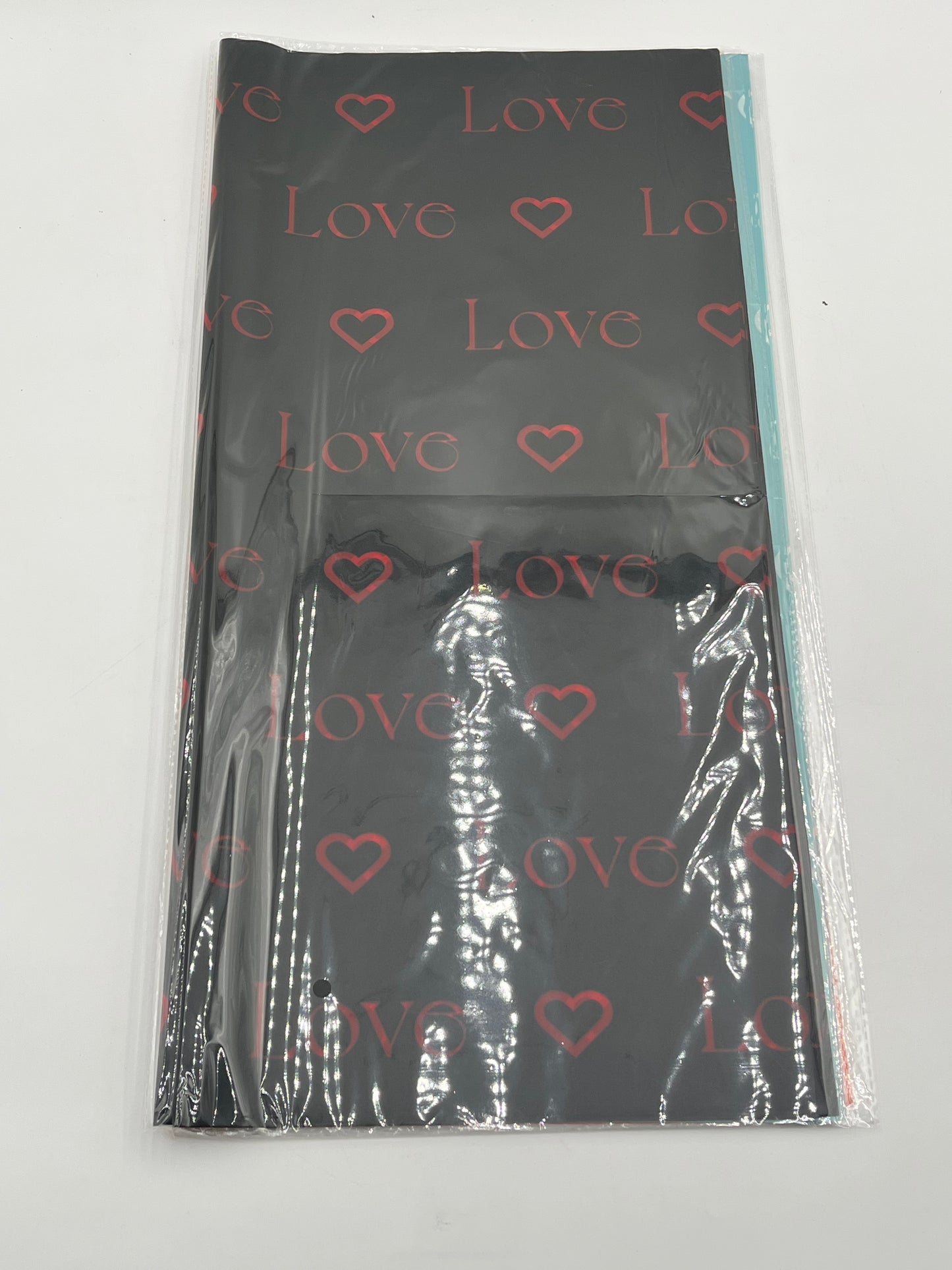 LOVE Wraps Edition in Black, 22x22 inch sheets with heart and “LOVE” design. Sold @ floralsuppliespoint1.com for $9.99