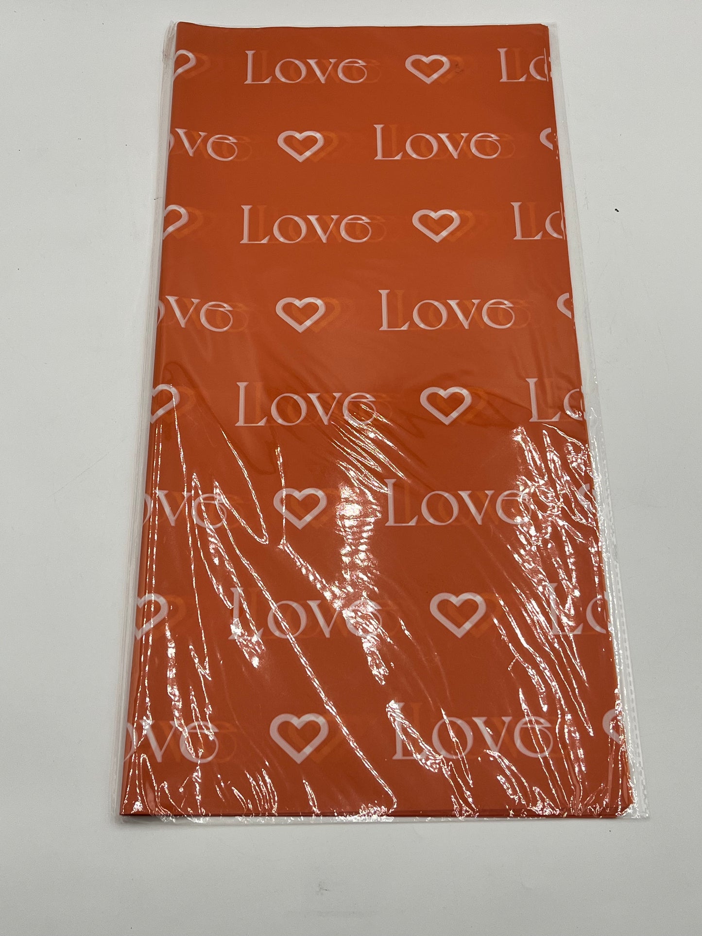LOVE Wraps Edition in Orange, 22x22 inch sheets with heart and “LOVE” design. Sold @ floralsuppliespoint1.com for $9.99