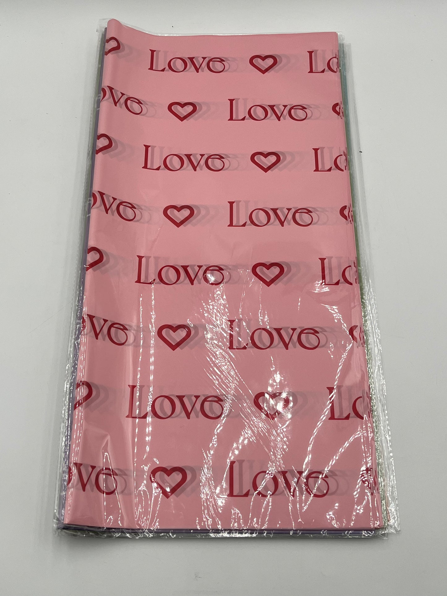 LOVE Wraps Edition in Pink, 22x22 inch sheets with heart and “LOVE” design. Sold @ floralsuppliespoint1.com for $9.99