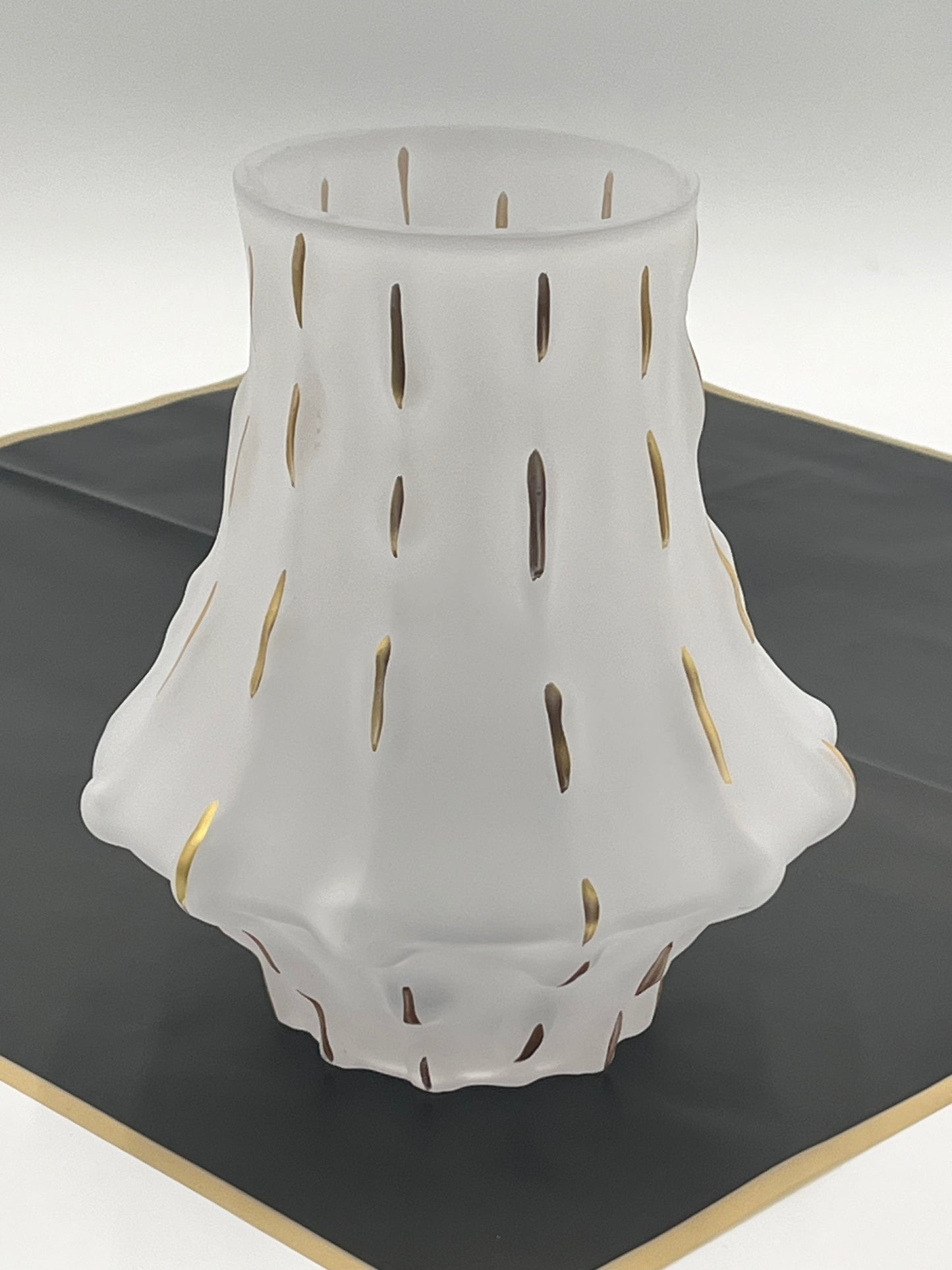 Midnight Ember in matte white vase showcases a dramatic & sculptural silhouette, providing a sophisticated, modern backdrop for the decorative accents.