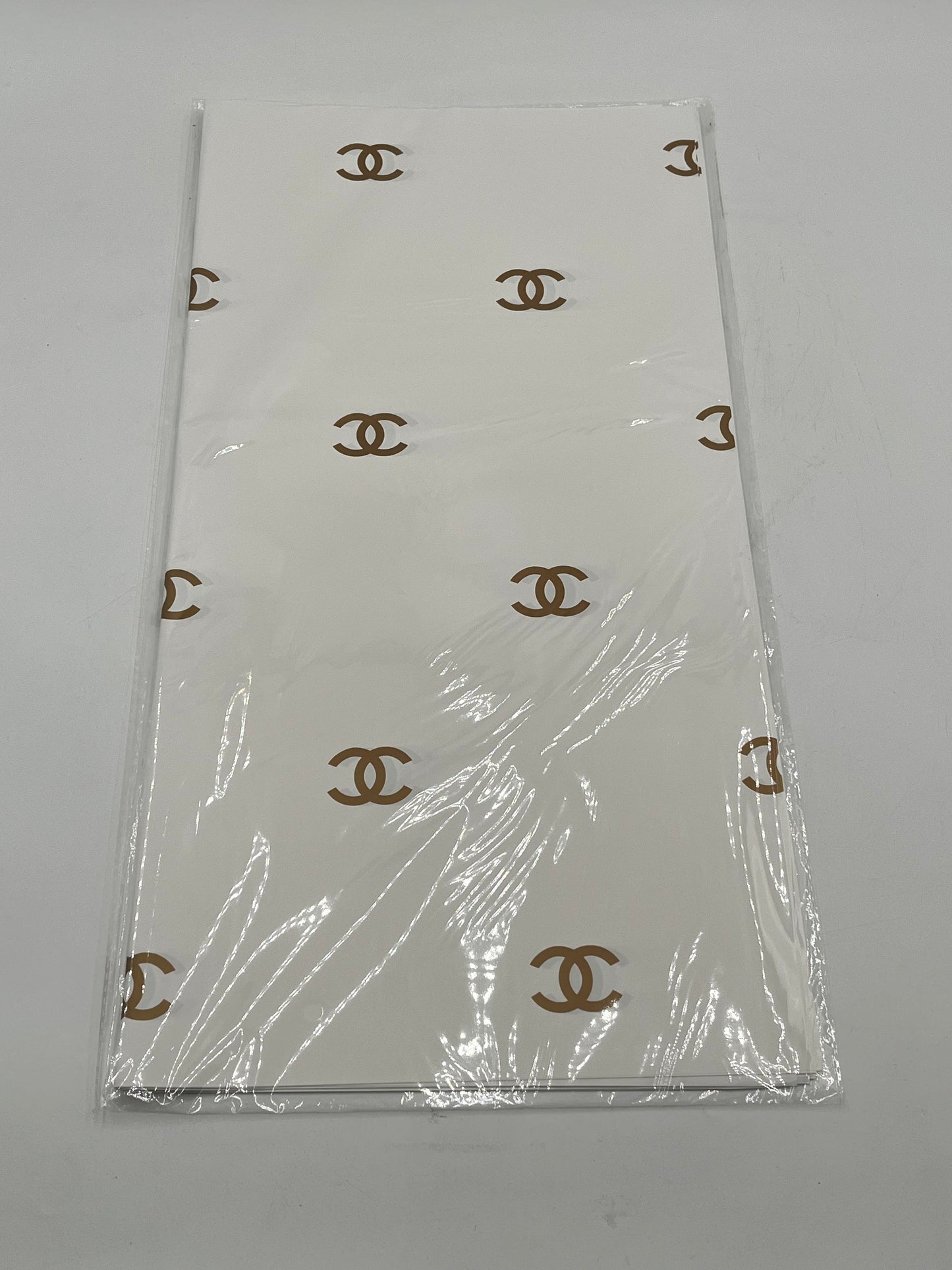 Paris Luxe CC Collection– in white/gold, designer-inspired wrapping papers with gold & black logos. 20 sheet pack for $9.99 each by floralsuppliespoint1.com
