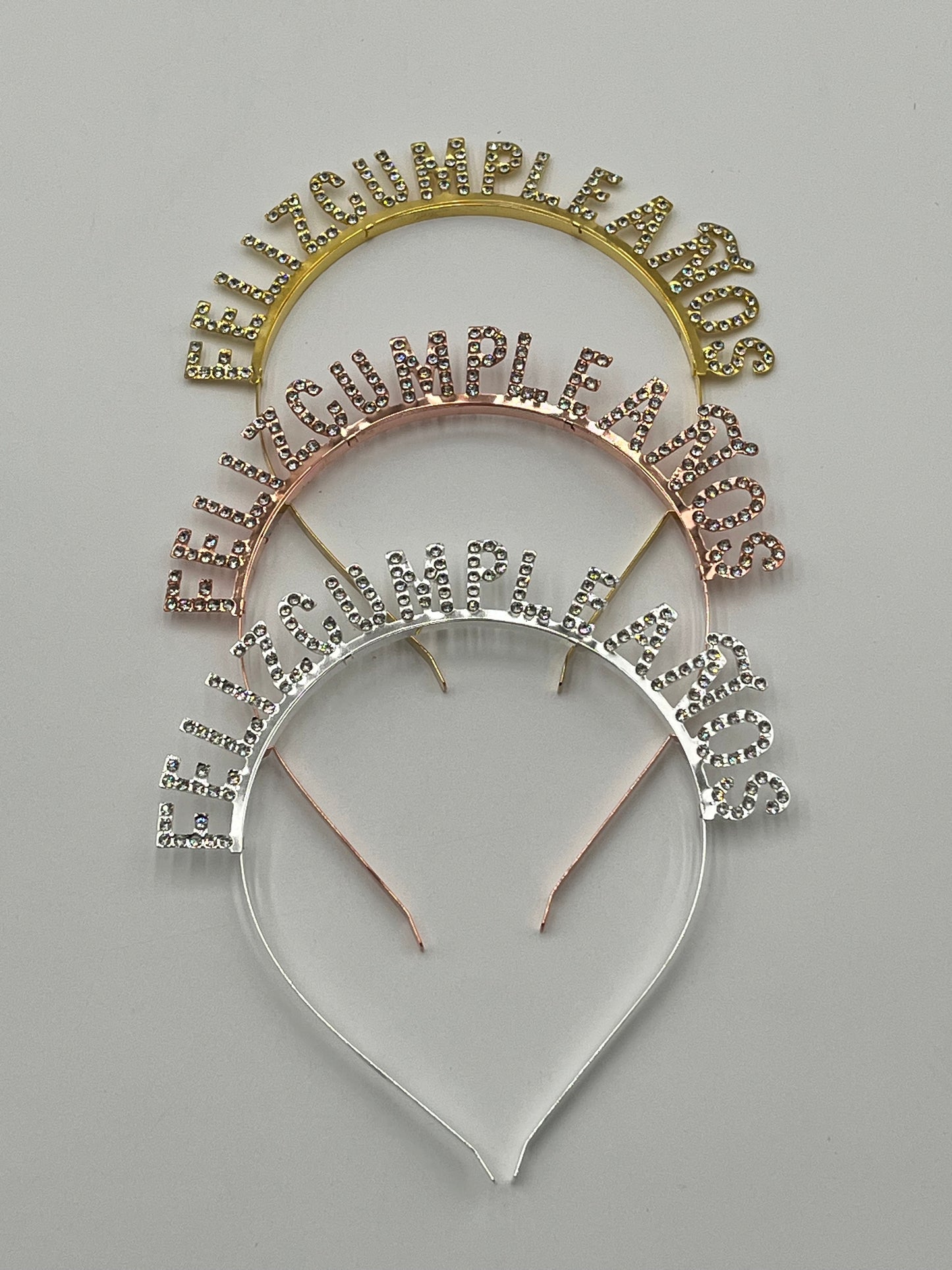 Gold, rose gold & silver Rhinestone "Feliz Cumpleaños" headbands, 5" tall, sold retail & wholesale by floralsuppliespoint1.com.