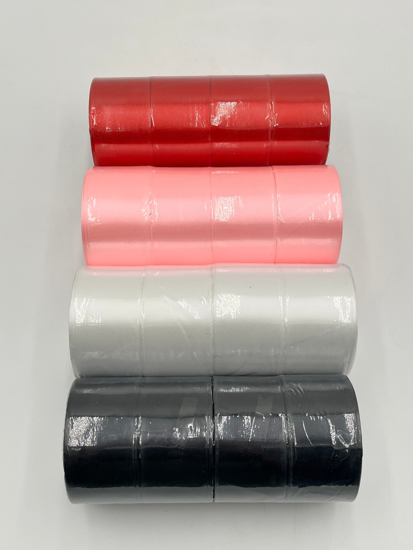 Satin ribbon rolls 1.5" & 2" x 25 yards in Red, Pink, White & Black. Sold individually or in packs by floralsuppliespoint1.com.