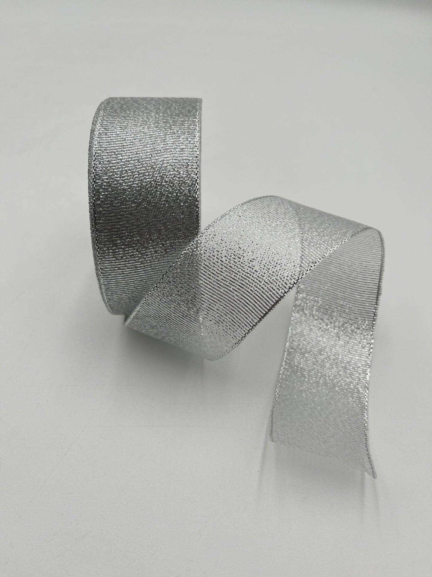 Silver polyester ribbon roll in 2” x 25 yards, ideal for floral design, gifts and crafts. Sold individually by floralsuppliespoint1.com.