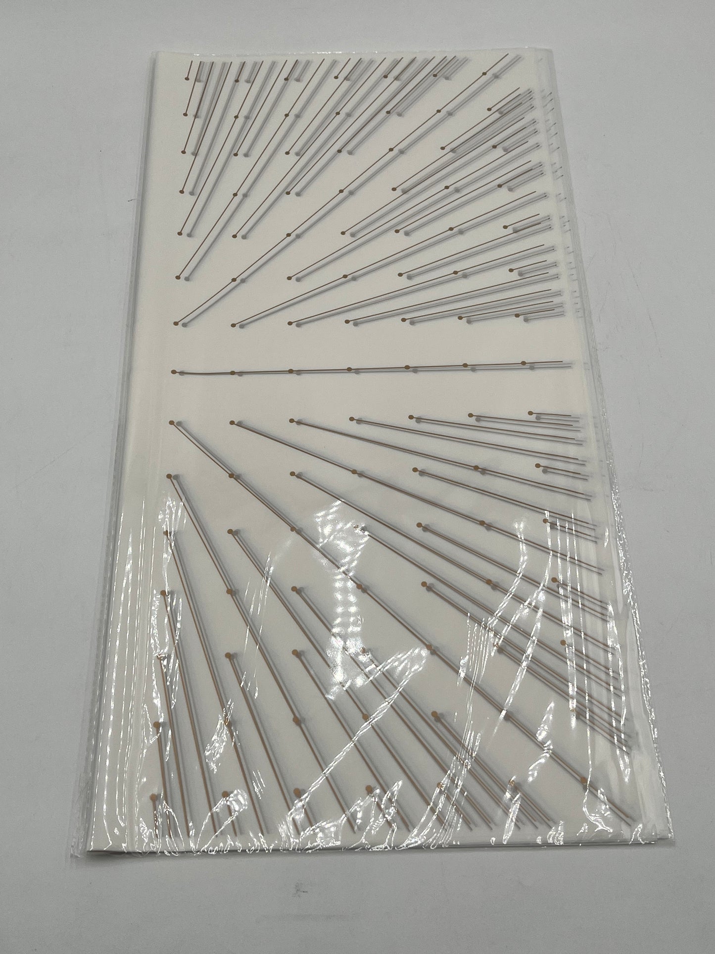 Starlight Burst floral wrapping paper with gold burst accents, available in White, 22x22", 20 per pack for $9.99. Available @ floralsuppliespoint1.com