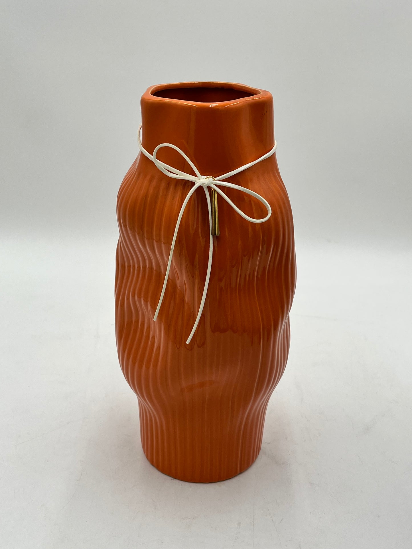 Modern & sophisticated 13"x3" ceramic vases with tassel detail in Orange. Sold by floralsuppliespoint1.com for $19.99 each