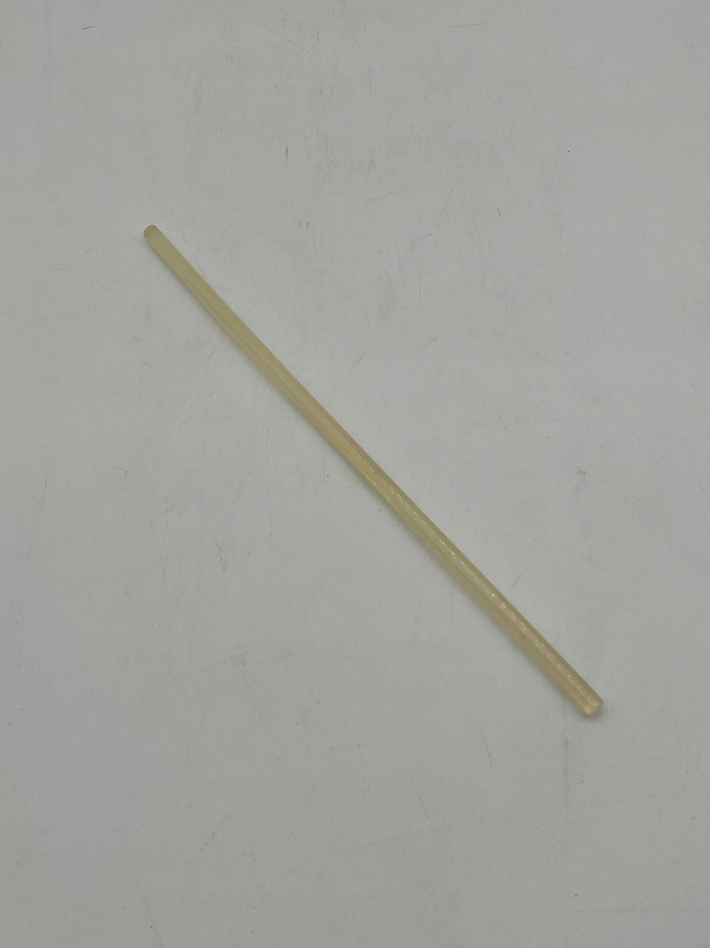 A yellow hot glue gun stick for floral arrangements, crafts and DIY projects. Sold by floralsuppliespoint1.com.