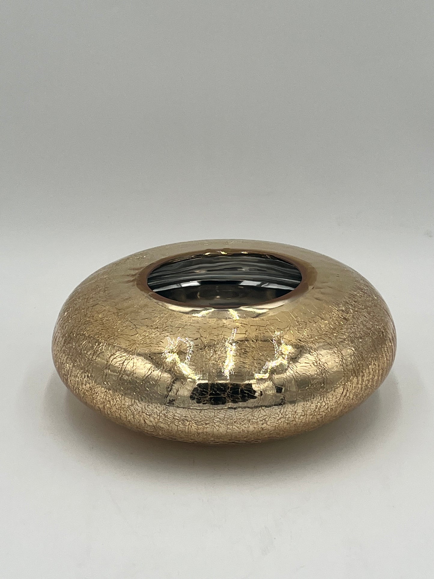The Velantura 3.5x4 Op vase by Floral Supplies Point features a round, flat shape with a small central opening, cracked textured surface, and glossy gold finish—perfect as a stunning accent on any plain white background.