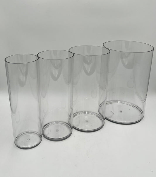 Clear plastic cylinder vases in four sizes for floral design, candles, or decor use. Lightweight and modern. Sold individually by floralsuppliespoint1.com.