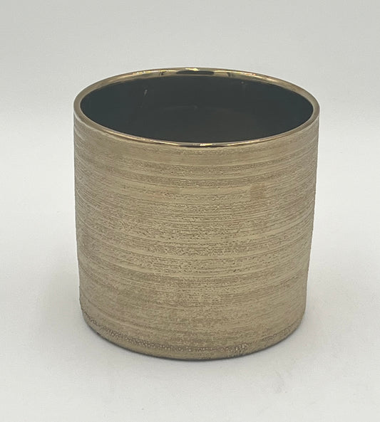The Bruma Cyl 5.5x5.5 Op by Floral supplies Point is a ceramic pot with a matte brushed gold exterior and smooth, dark interior, ideal for modern interiors and shown against a plain white background.