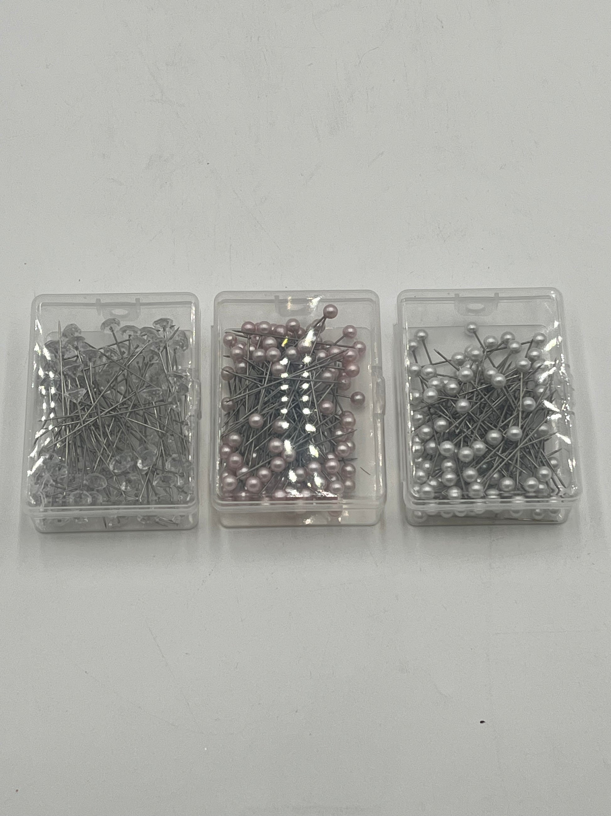 Decorative floral pins in pearl white, pink & diamond crystal styles, 50 pcs per box. Sold retail or wholesale 10-packs by floralsuppliespoint1.com.