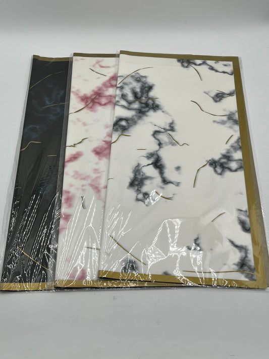 Gilded Marble Trio 22x22 inch (20 sheets) wrapping papers in Black, White with Red Veins, and White with Gray Veins. Sold by floralsuppliespoint1.com for $9.99.