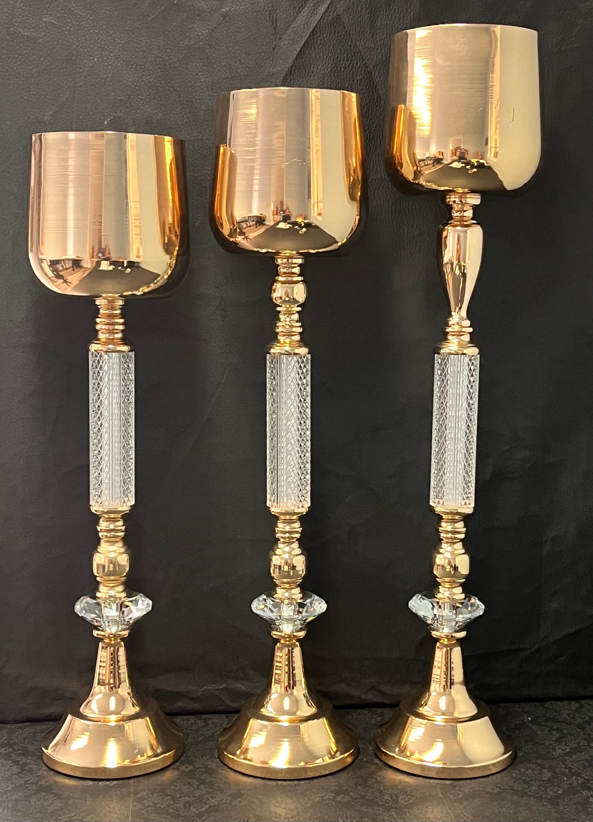 Golden Glow Vase Set in gold with clear crystal stem accents in three sizes for luxury floral arrangements. Sold individually or as a set at floralsuppliespoint1.com.