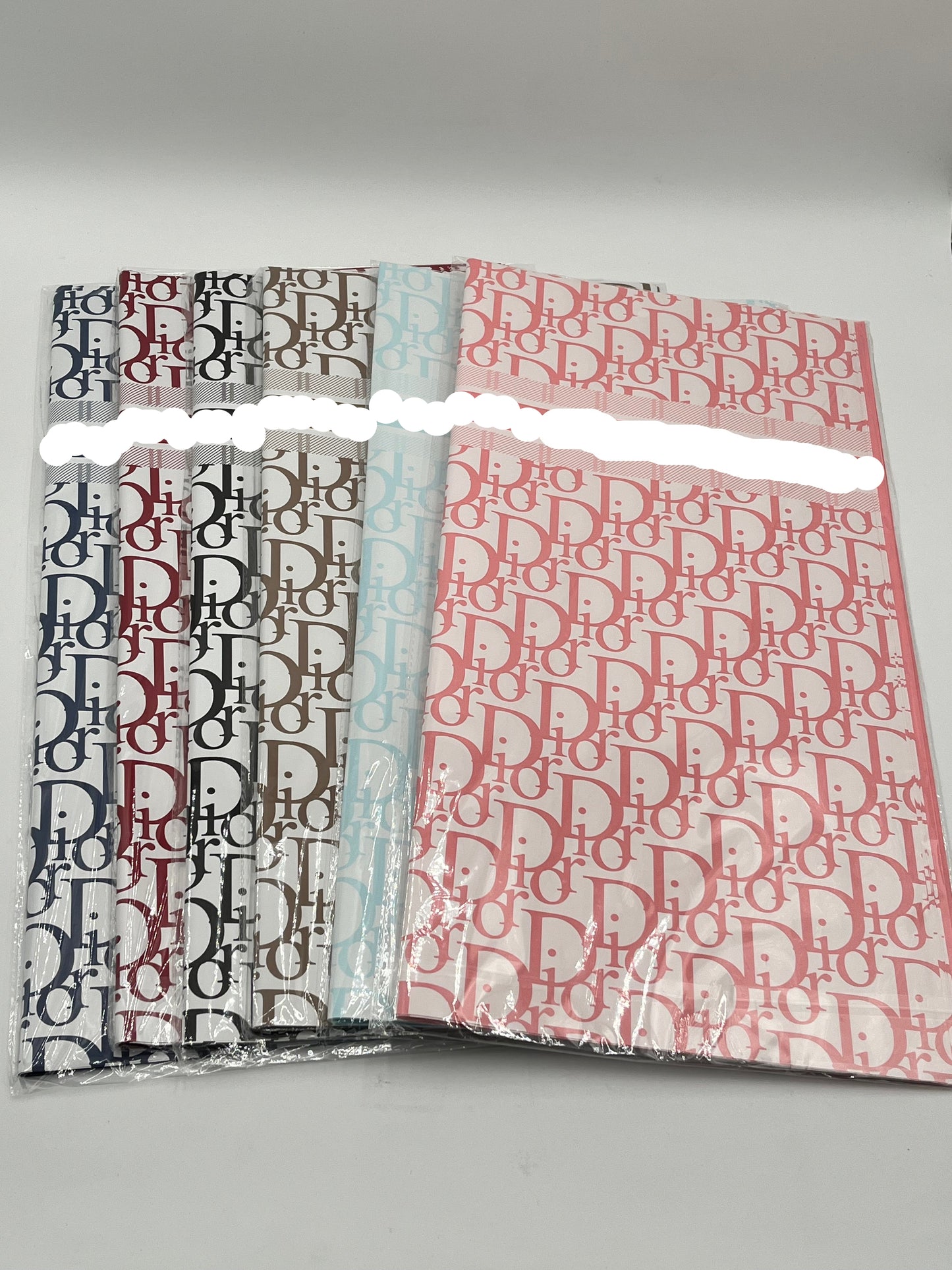 22x22 inch floral wrapping paper with iconic CD monogram in Dark Blue, Red Wine, Black, Brown, Light Blue & Pink.Sold by floralsuppliespoint1.com for $9.99