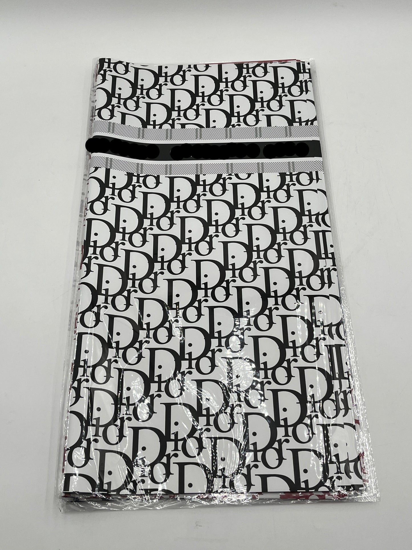 22x22 inch floral wrapping paper with iconic CD monogram in Black.Sold by floralsuppliespoint1.com for $9.99