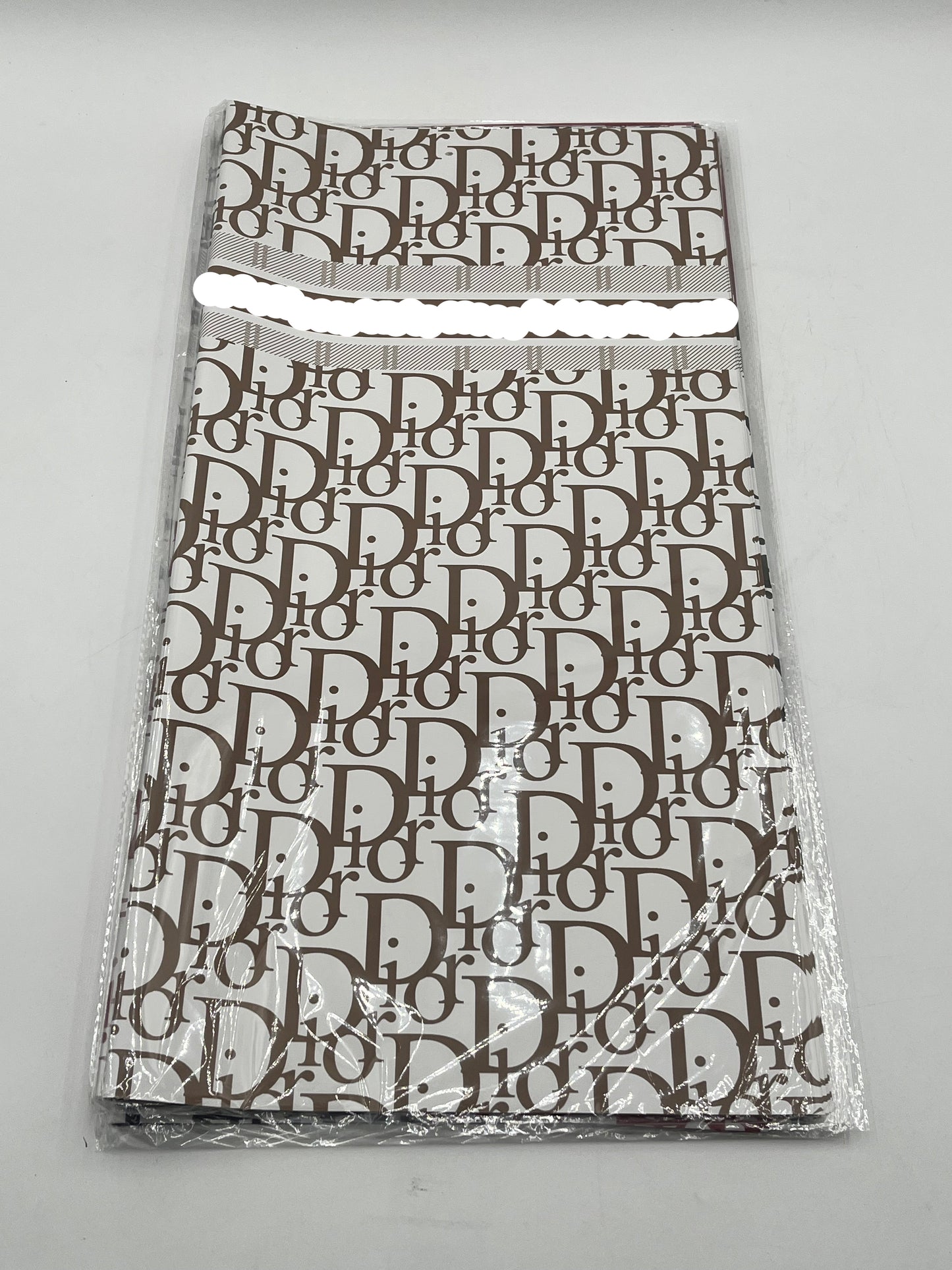 22x22 inch floral wrapping paper with iconic CD monogram in Brown.Sold by floralsuppliespoint1.com for $9.99