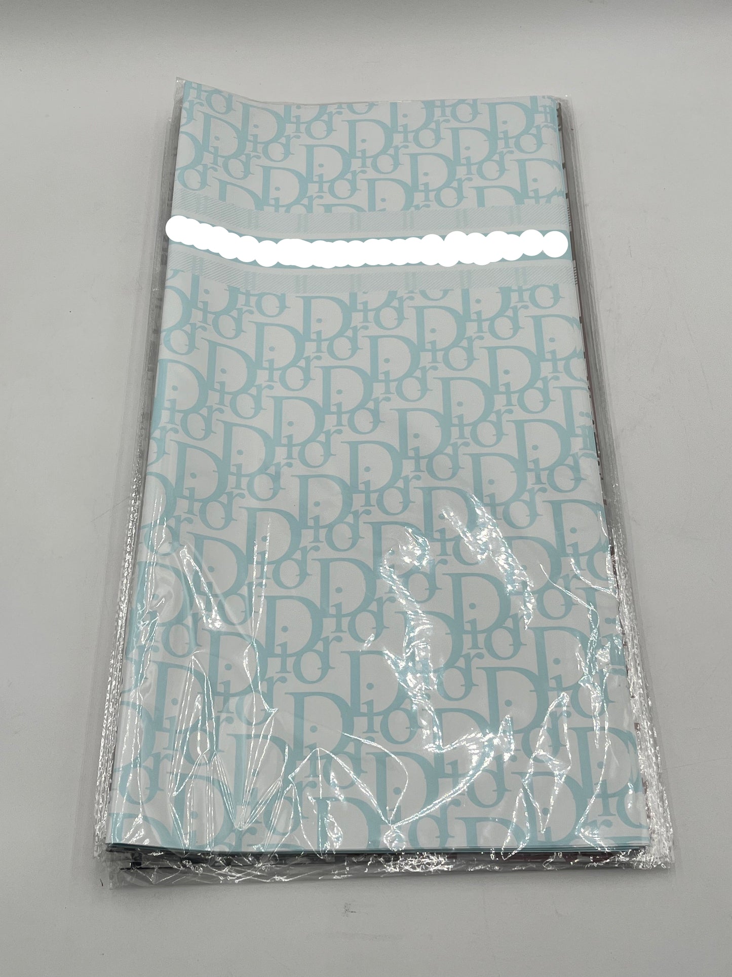 22x22 inch floral wrapping paper with iconic CD monogram in Light Blue.Sold by floralsuppliespoint1.com for $9.99