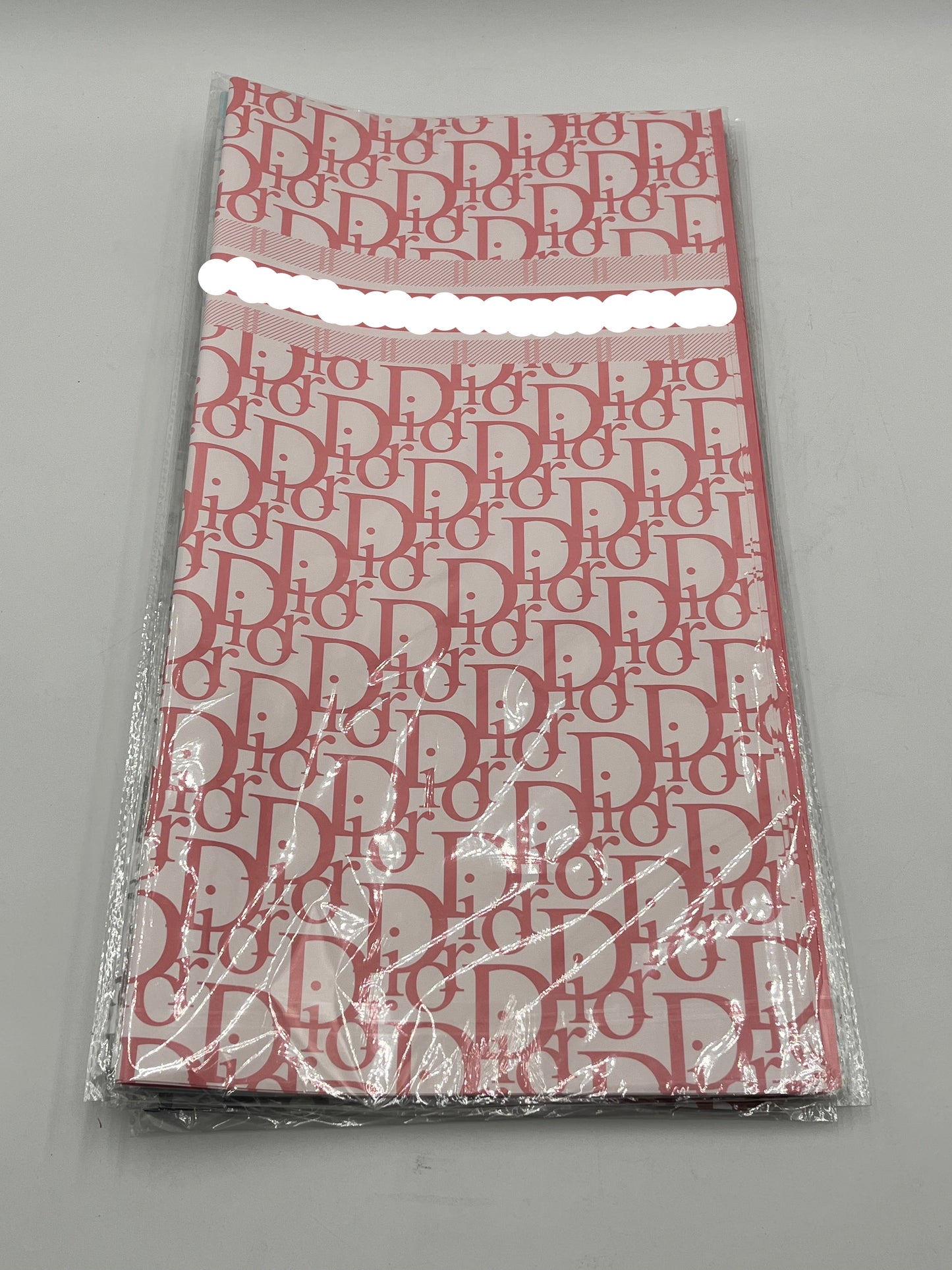 22x22 inch floral wrapping paper with iconic CD monogram in Pink.Sold by floralsuppliespoint1.com for $9.99