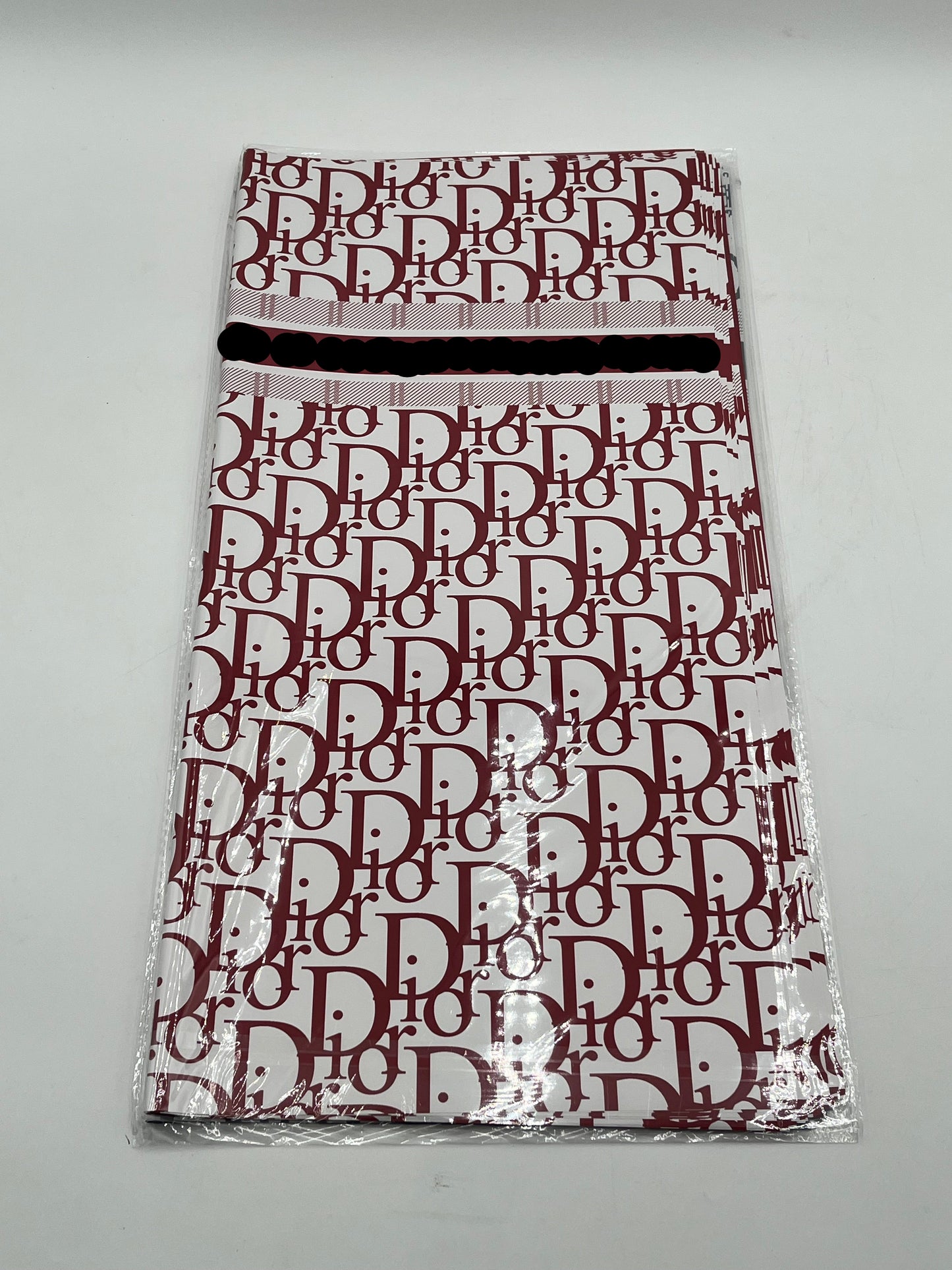 22x22 inch floral wrapping paper with iconic CD monogram in Red Wine.Sold by floralsuppliespoint1.com for $9.99