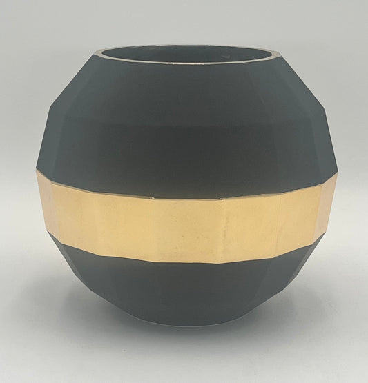 The Stratos Core 7x4 Op vase by Floral Supplies Point features a matte black, faceted round design with a wide gold band, creating a sculptural centerpiece that radiates grounded luxury against a plain white background.