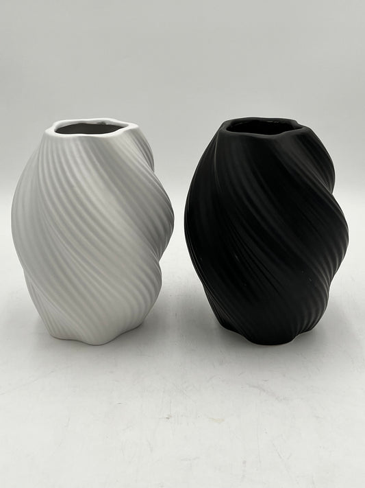 Decorative ceramic vase with a modern spiral design, perfect for elegant and minimalist interiors. Sold by floralsuppliespoint1.com for $10.99 in black or white