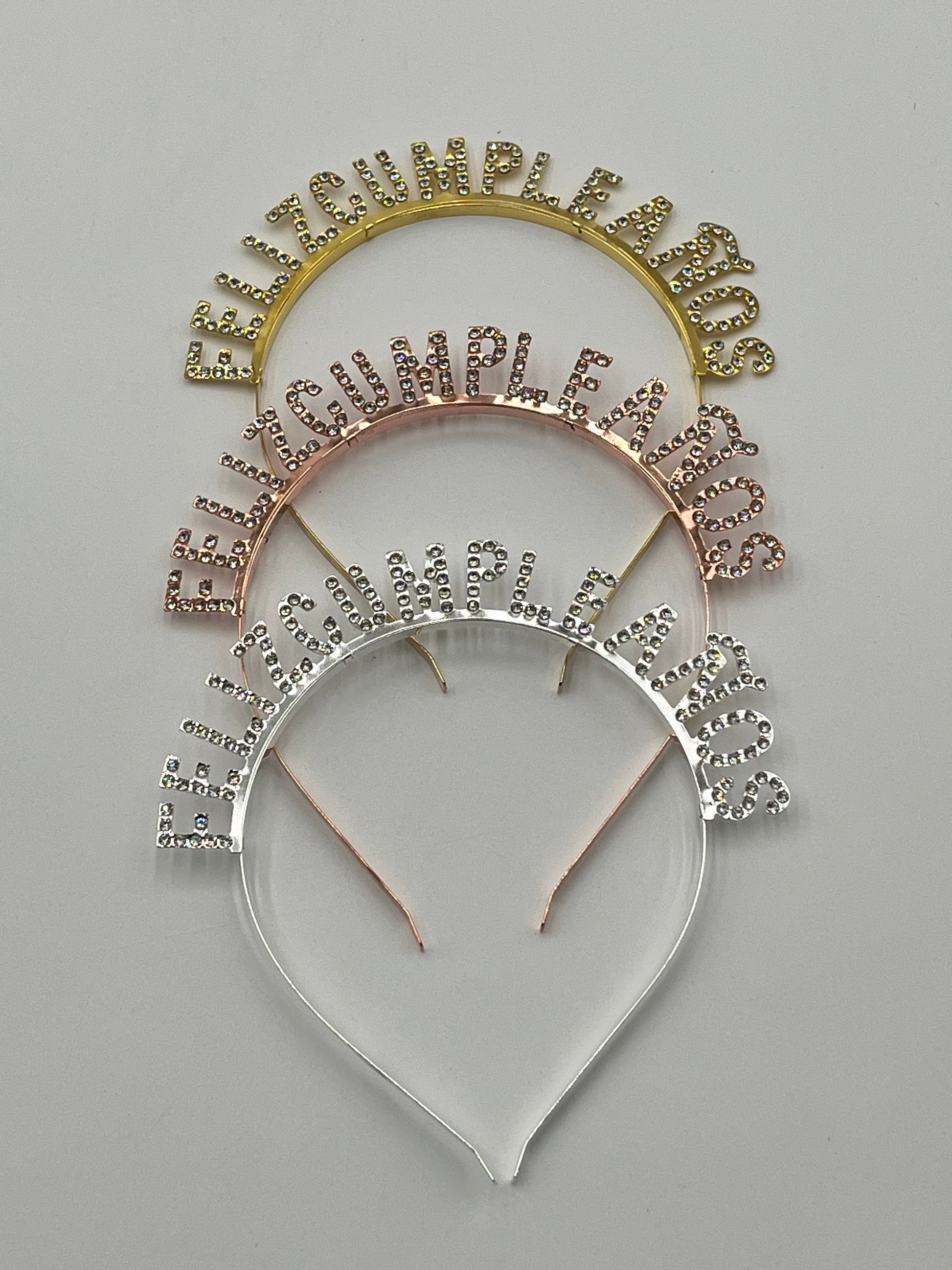 Gold, rose gold & silver Rhinestone "Feliz Cumpleaños" headbands, 5" tall, sold retail & wholesale by floralsuppliespoint1.com.