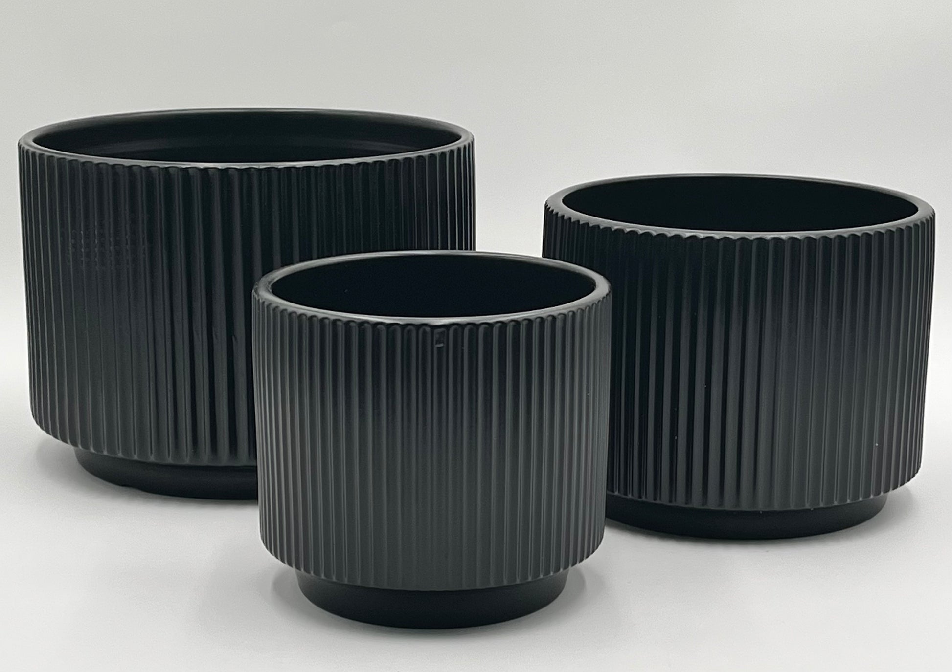 Ridge Nest Set of 3 ribbed ceramic vases in black with sizes 5.75x5.75", 6.25x7", and 7.25x9" (height x opening), total 11.80 lbs, available in black or white at floralsuppliespoint1.com.