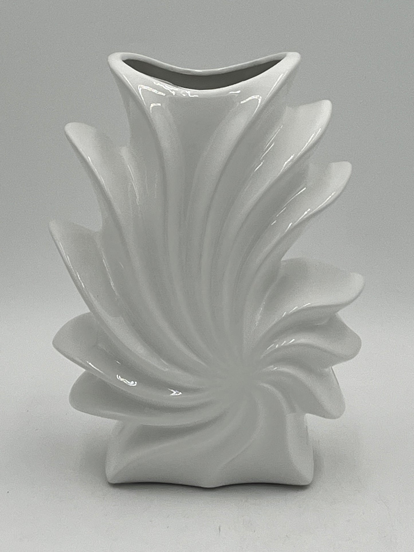 Shellflare ceramic vases in glossy white with sculptural ocean swirl design, 10" x 3.5", 2.10 lbs each, available at floralsuppliespoint1.com. Ideal for bold floral accents.