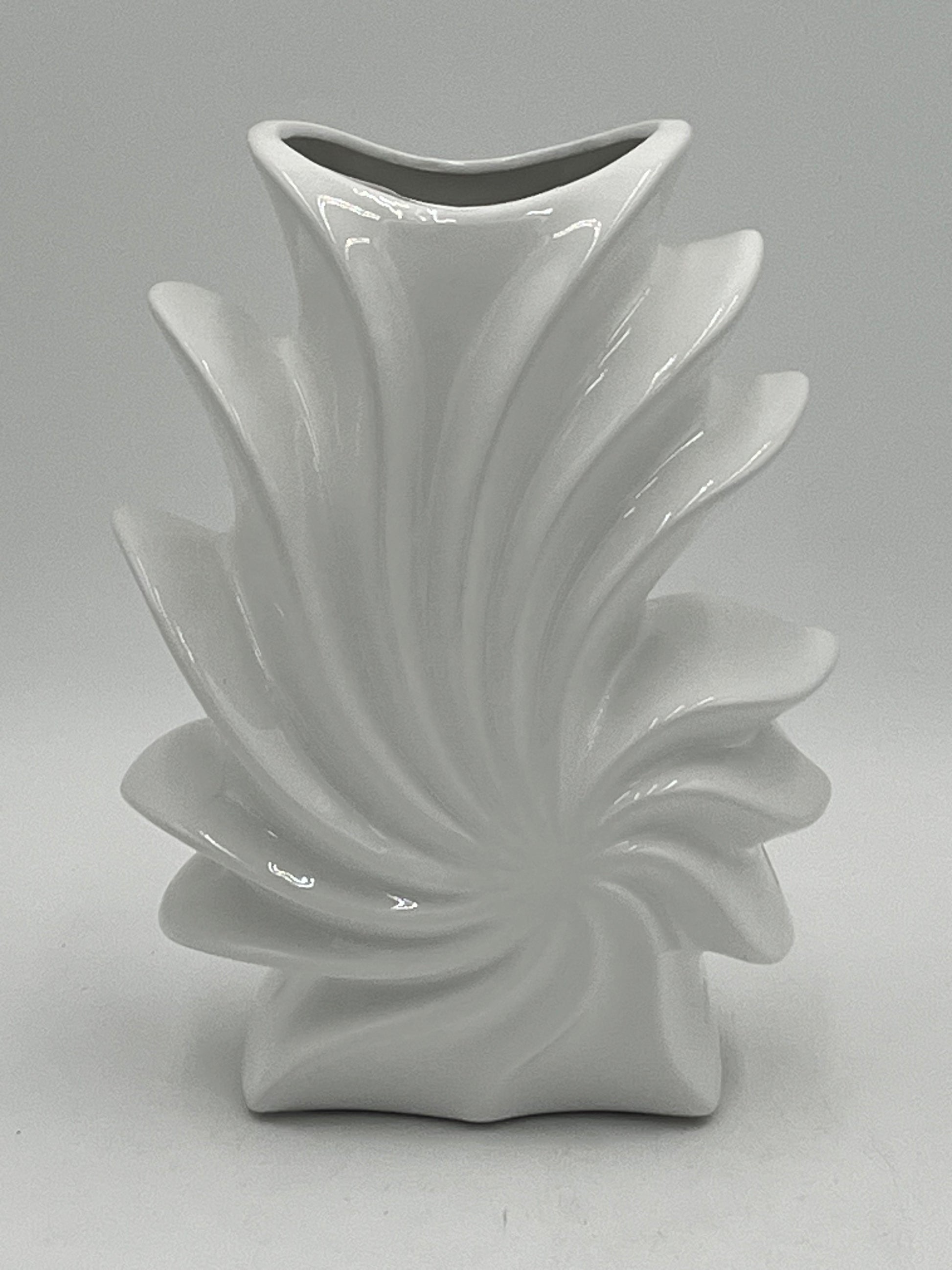Shellflare ceramic vases in glossy white with sculptural ocean swirl design, 10" x 3.5", 2.10 lbs each, available at floralsuppliespoint1.com. Ideal for bold floral accents.