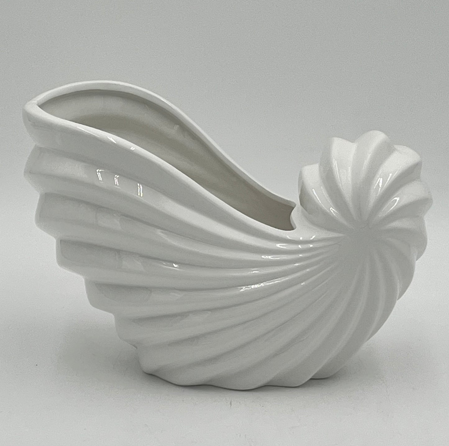 Shellglo ceramic vases in glossy white with spiral shell design, 6" x 6.5", 1.60 lbs each, sold by floralsuppliespoint1.com. Ideal for coastal floral decor and small arrangements.