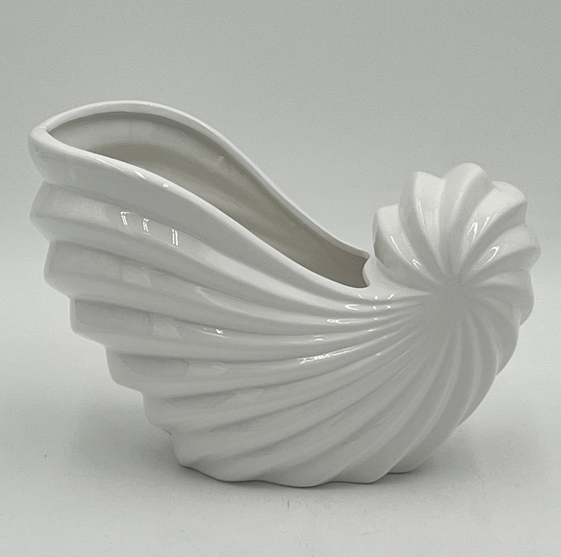 Shellglo ceramic vases in glossy white with spiral shell design, 6" x 6.5", 1.60 lbs each, sold by floralsuppliespoint1.com. Ideal for coastal floral decor and small arrangements.
