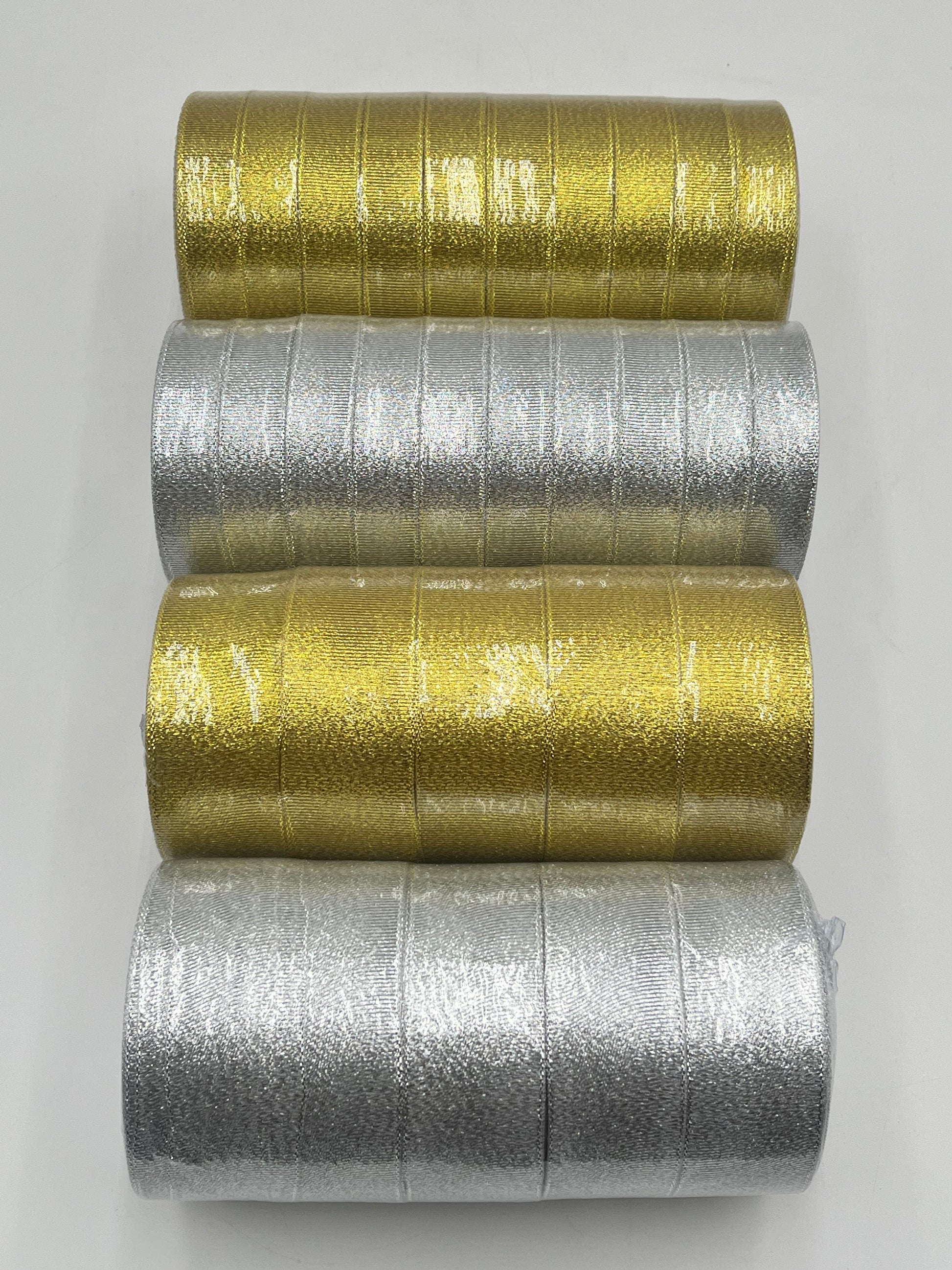Gold and silver polyester ribbon rolls in 1" or 2" x 25 yards, ideal for floral design, gifts and crafts. Sold individually or packs by floralsuppliespoint1.com