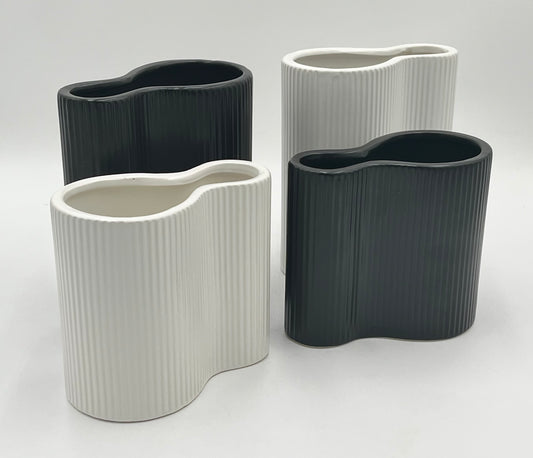 Twin Current vases in matte black and white with ribbed texture, sold by floralsuppliespoint1.com. Includes medium (8"x6") and small (6"x6") ceramic vases for modern floral designs.