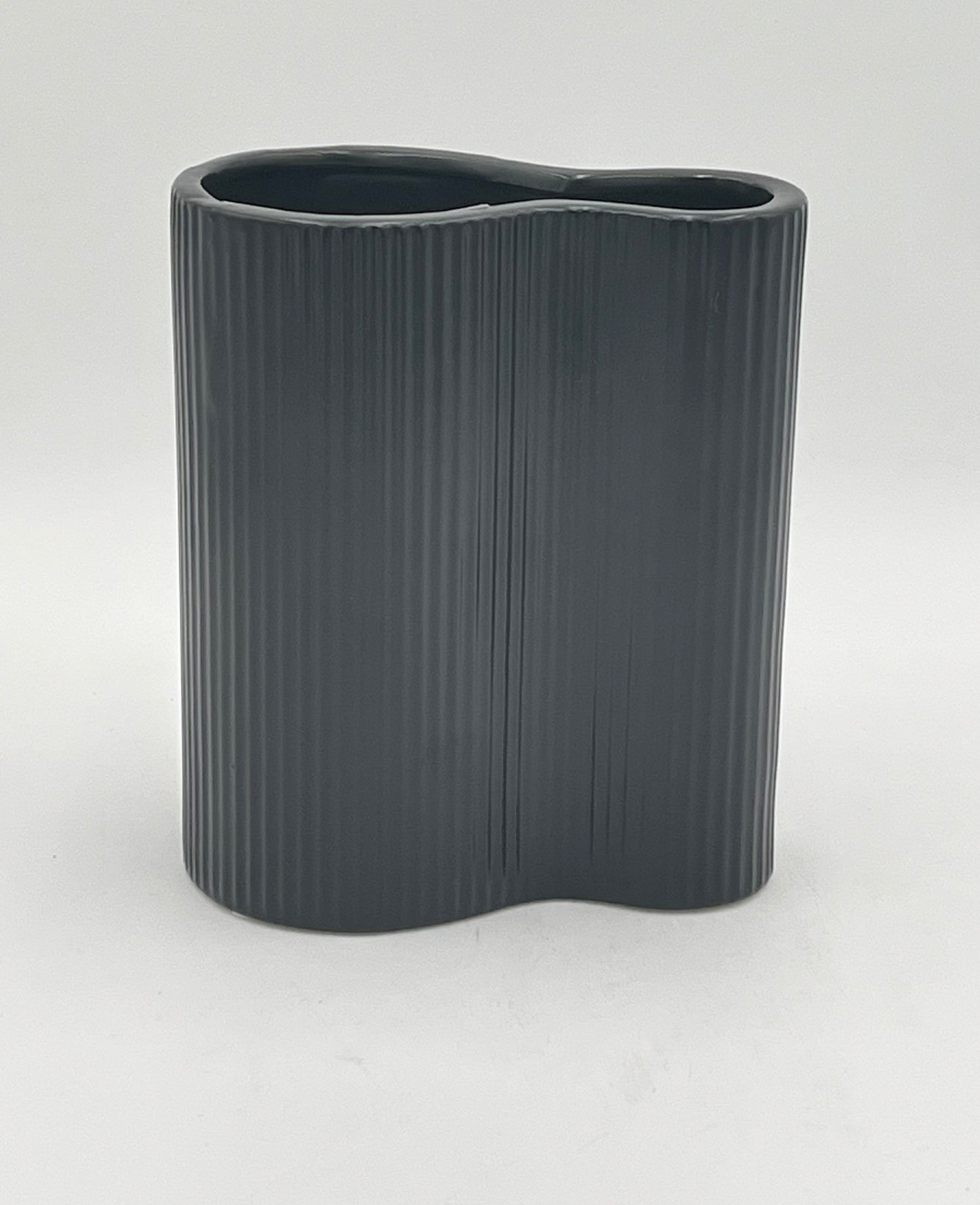 Twin Current vase in matte black with ribbed texture, sold by floralsuppliespoint1.com. Includes medium (8"x6") and small (6"x6") ceramic vases for modern floral designs.