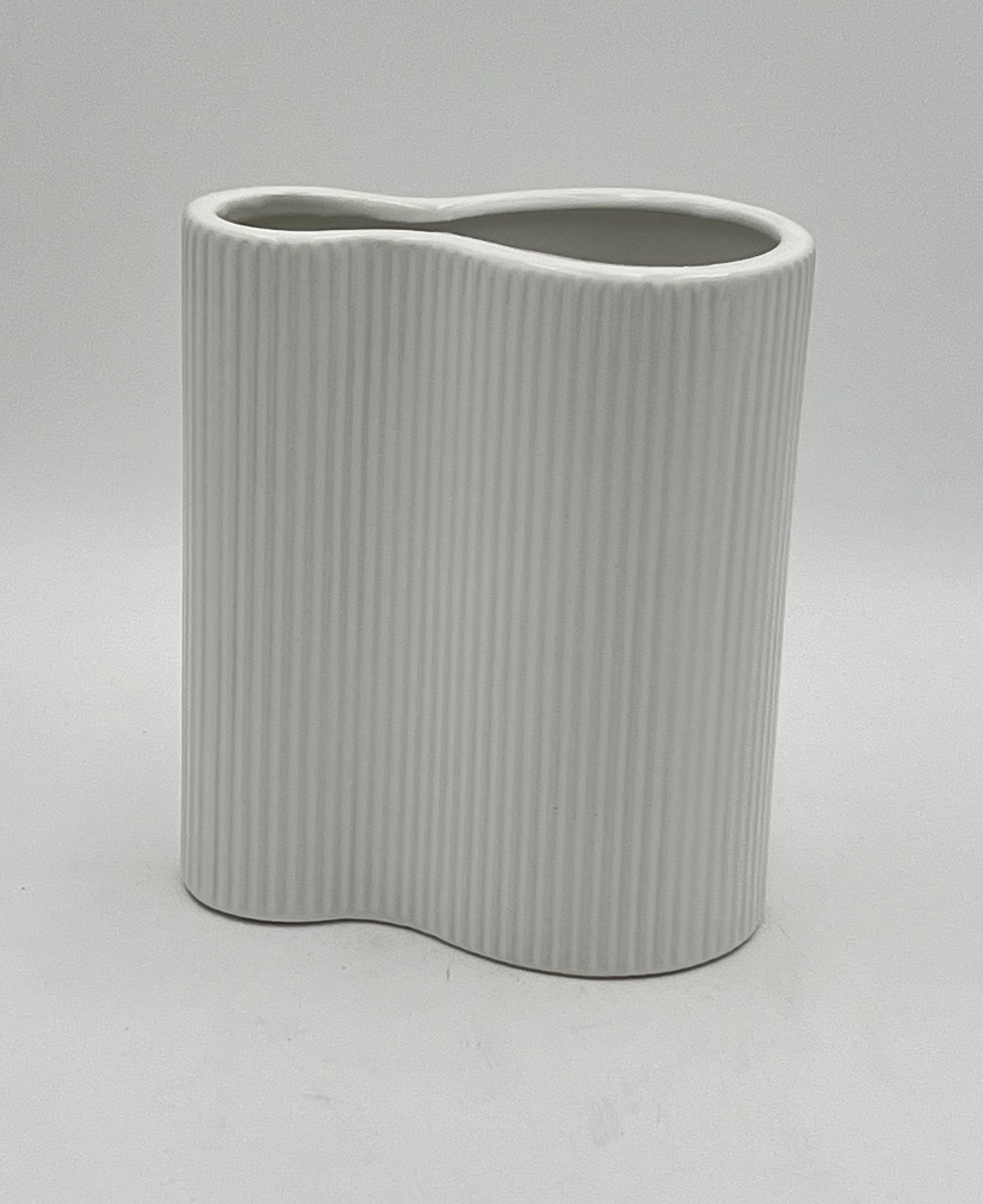 Twin Current vases in matte white with ribbed texture, sold by floralsuppliespoint1.com. Includes medium (8"x6") and small (6"x6") ceramic vases for modern floral designs.