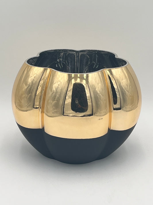 The Velora Bloom is a round, glossy ceramic vase with gold and black segments, vertical ridges & a wavy rim—perfect for adding modern luxury accent to any interior. Sold by floralsuppliespoint1.com