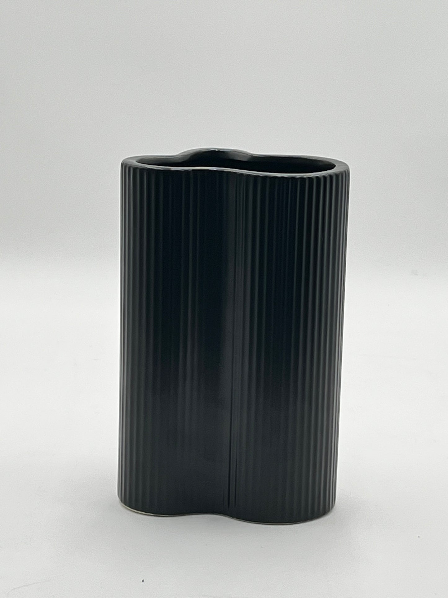 Waveline Core ceramic vase in Matte Black with ribbed design, sold by floralsuppliespoint1.com. Each vase measures 9" x 5" and weighs 2.30 lbs, perfect for modern floral arrangements.