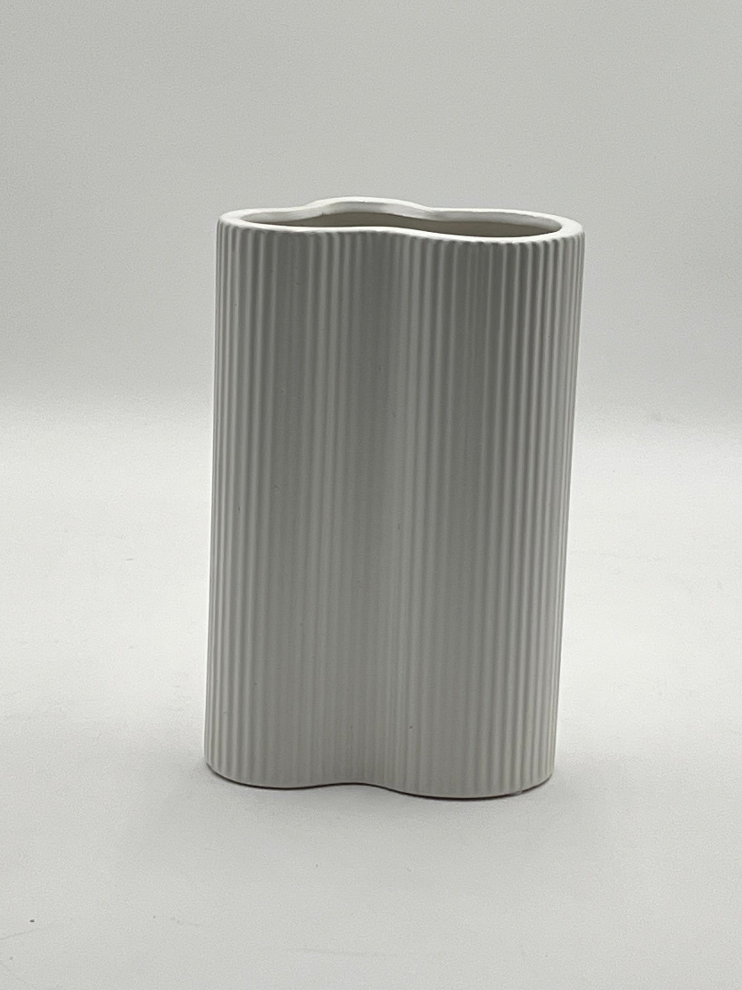 Waveline Core ceramic vase in Matte White, with ribbed design, sold by floralsuppliespoint1.com. Each vase measures 9" x 5" and weighs 2.30 lbs, perfect for modern floral arrangements.